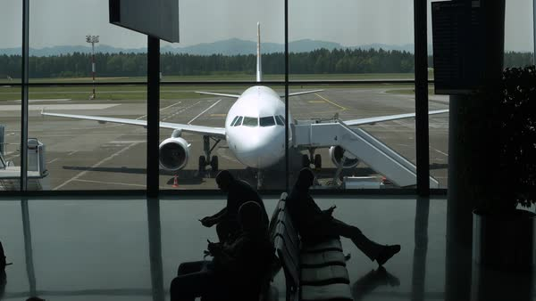 Stranded passengers sitting on their luggage